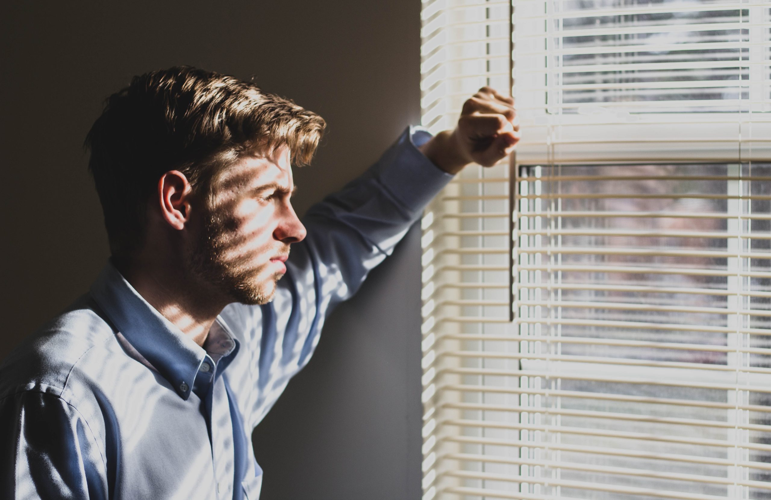 man looking out the window